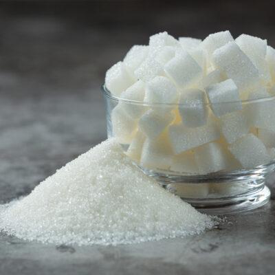World diabetes day;Sugar cubes in a glass bowl on dark floor